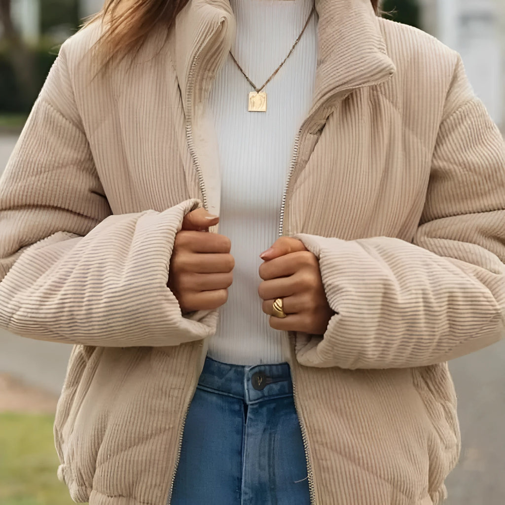 Apricot coloured women's corduroy jacket with stand collar and front zip, showing textured fabric.