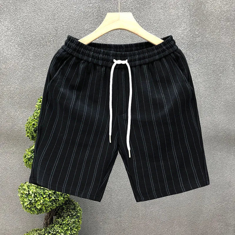 Men's black and white striped fleece-lined casual shorts showing double-layer waistband and straight-leg cut