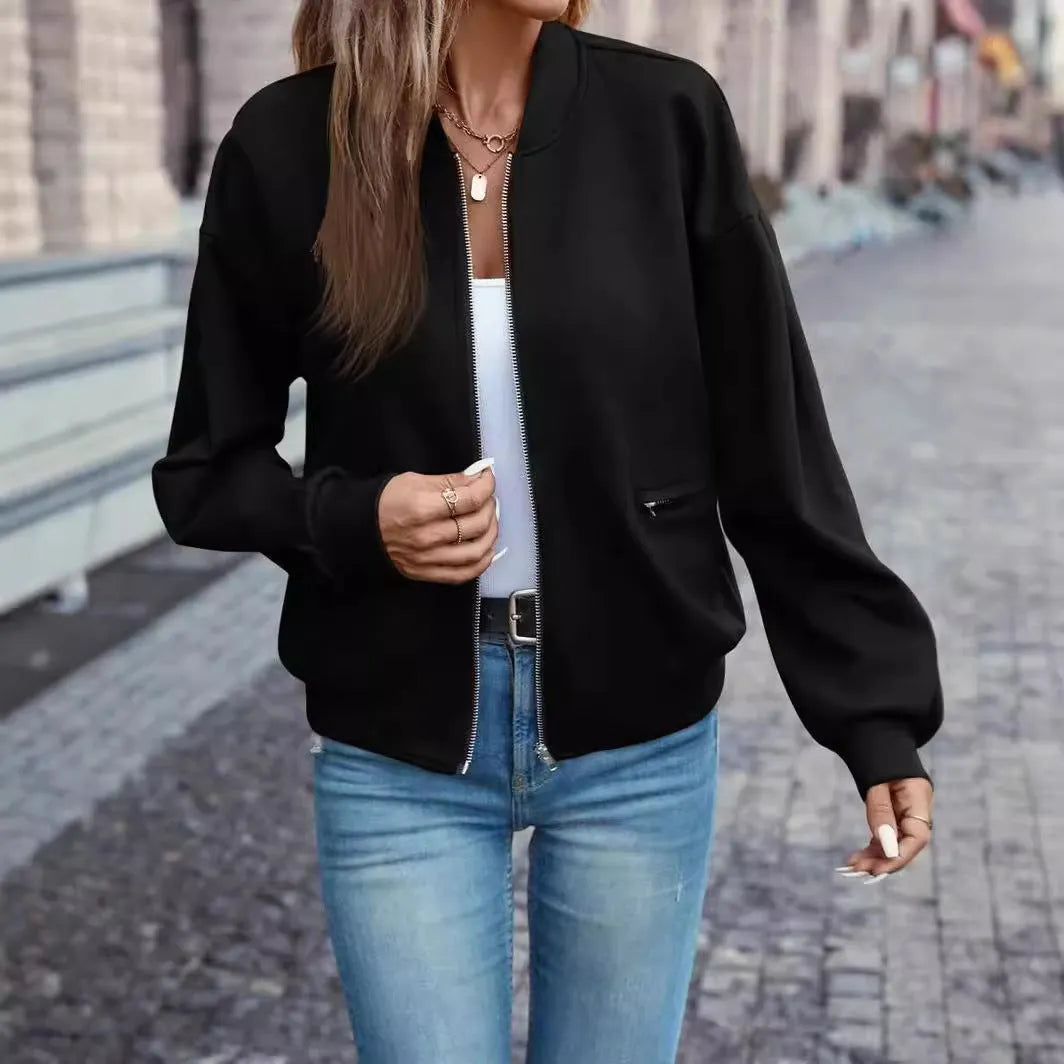Women's solid black polyester zip jacket with long sleeves and faux pockets