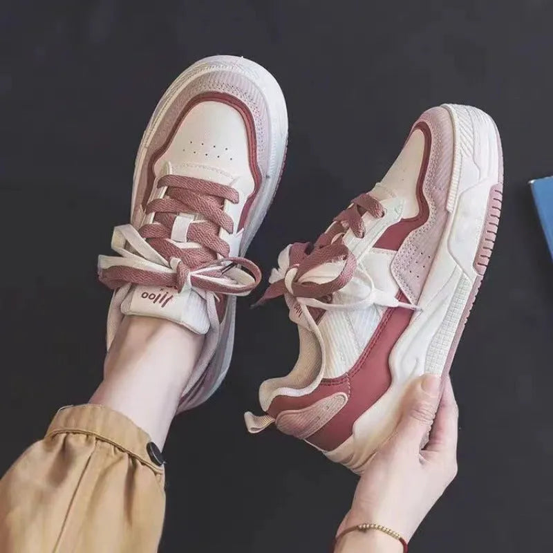 Beige and pink low-top platform sneakers with a rubber sole on a white background