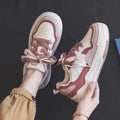 Beige and pink low-top platform sneakers with a rubber sole on a white background