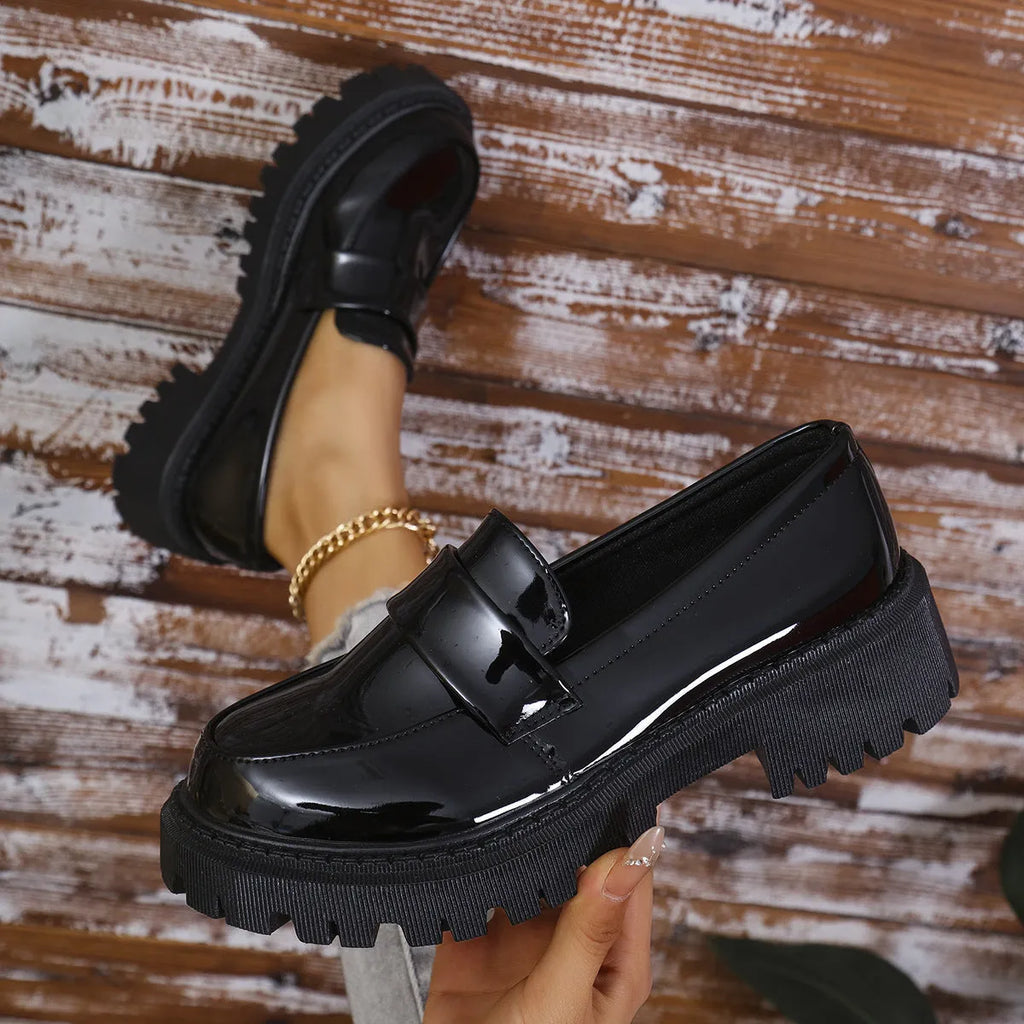 Women's black slip-on loafers with chunky platform heel and solid colour design