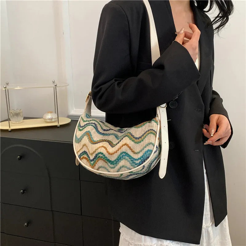 Women's straw woven crossbody bag with internal phone and document pockets in corrugated finish