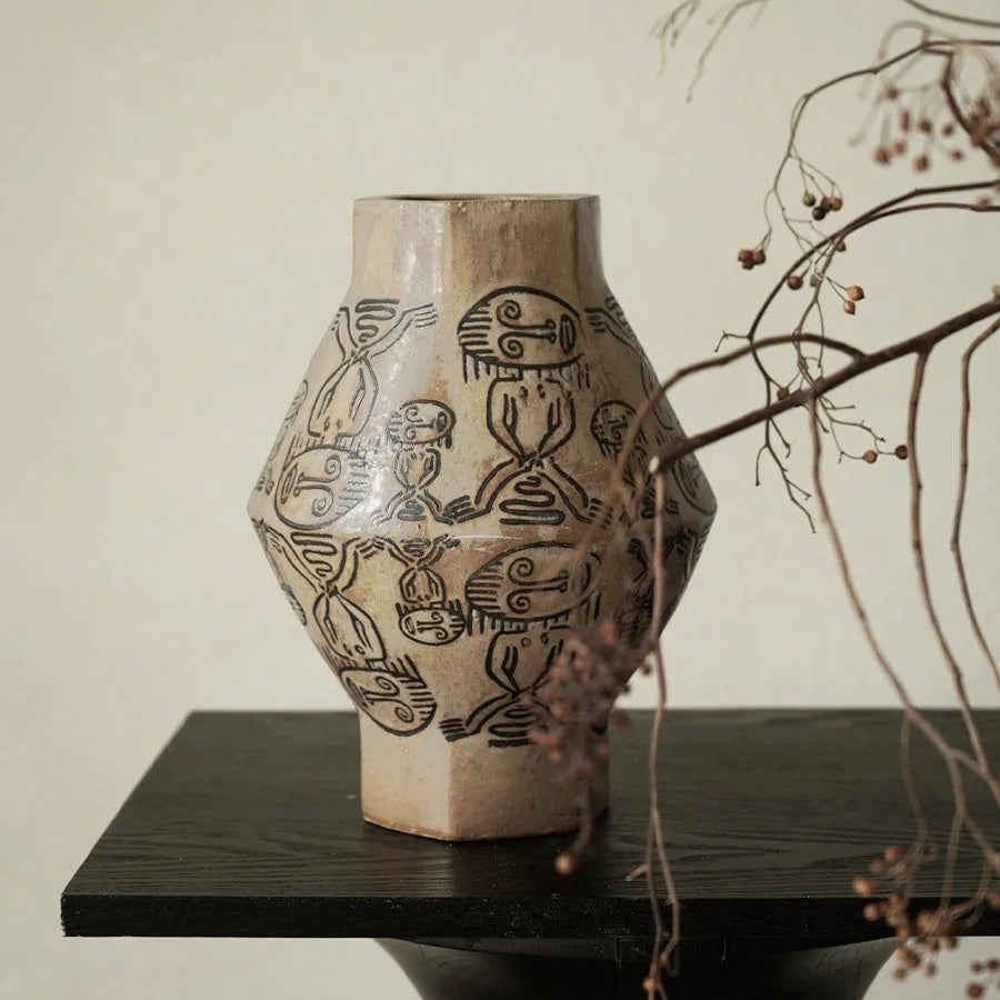 Hand-painted ceramic vase with vintage carved religious patterns in tribal totem colours