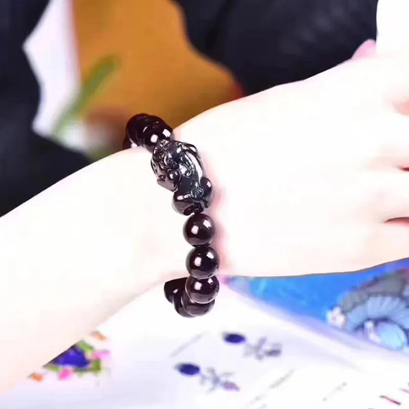 Natural ice colour obsidian crystal bracelet showing pale stone beads on wrist