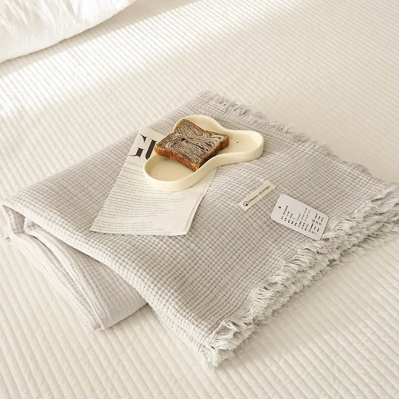 Four-layer gauze cotton blanket with tassel detailing in navy blue colour option