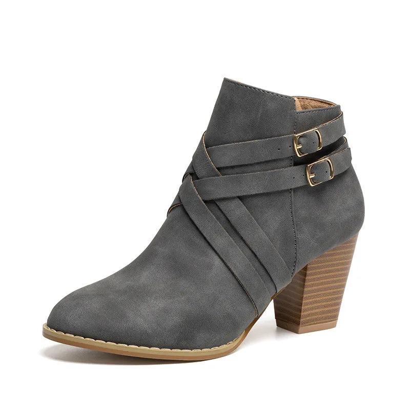 Women's black short boots with a 7cm stout heel and side zip fastener on a rubber sole.