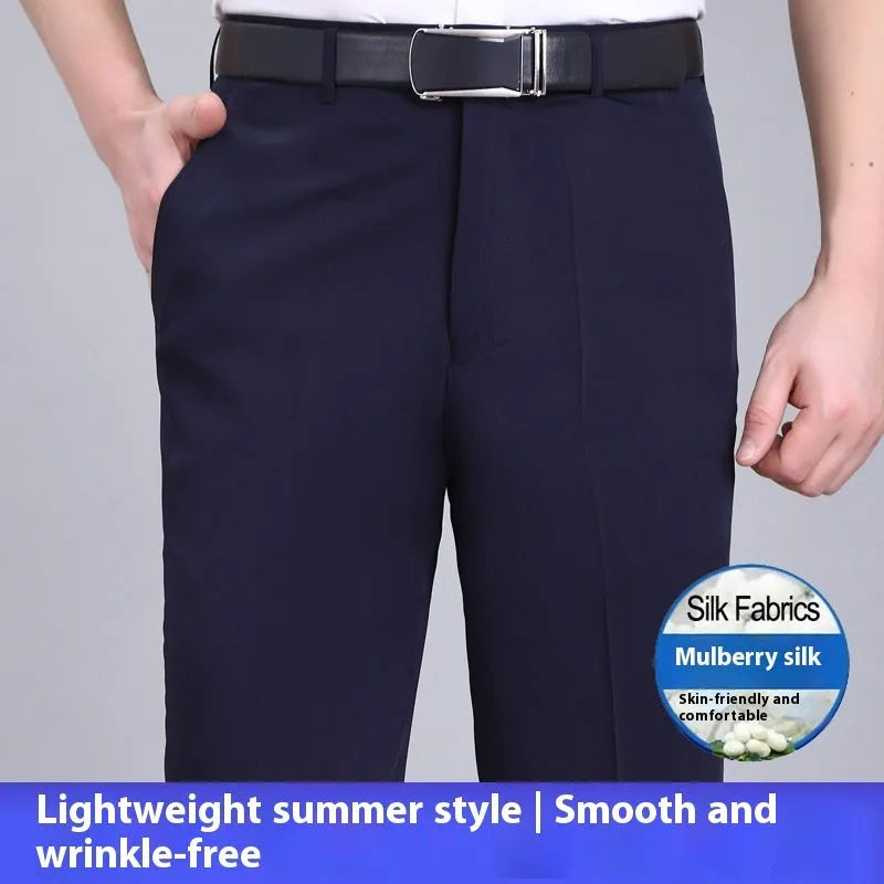Man wearing dark blue straight-leg suit trousers with a high waist, made from a mulberry silk blend fabric.