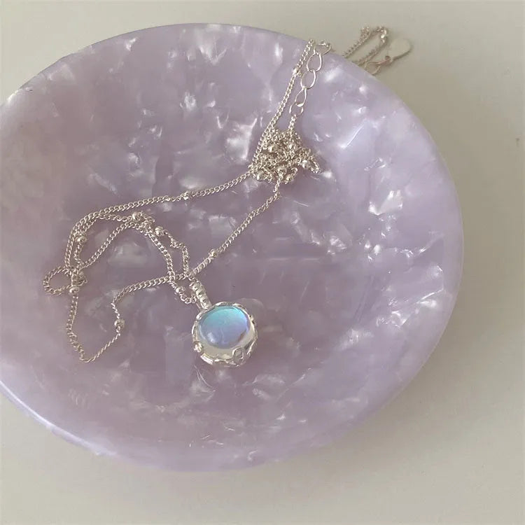 Women's silver ornamental stone necklace with geometric pendant on curb chain