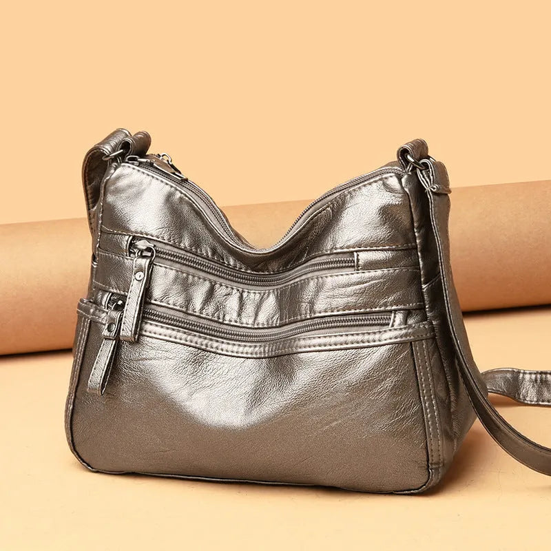 Women's washed leather crossbody bag in solid colour, retro messenger style with adjustable strap and soft handle