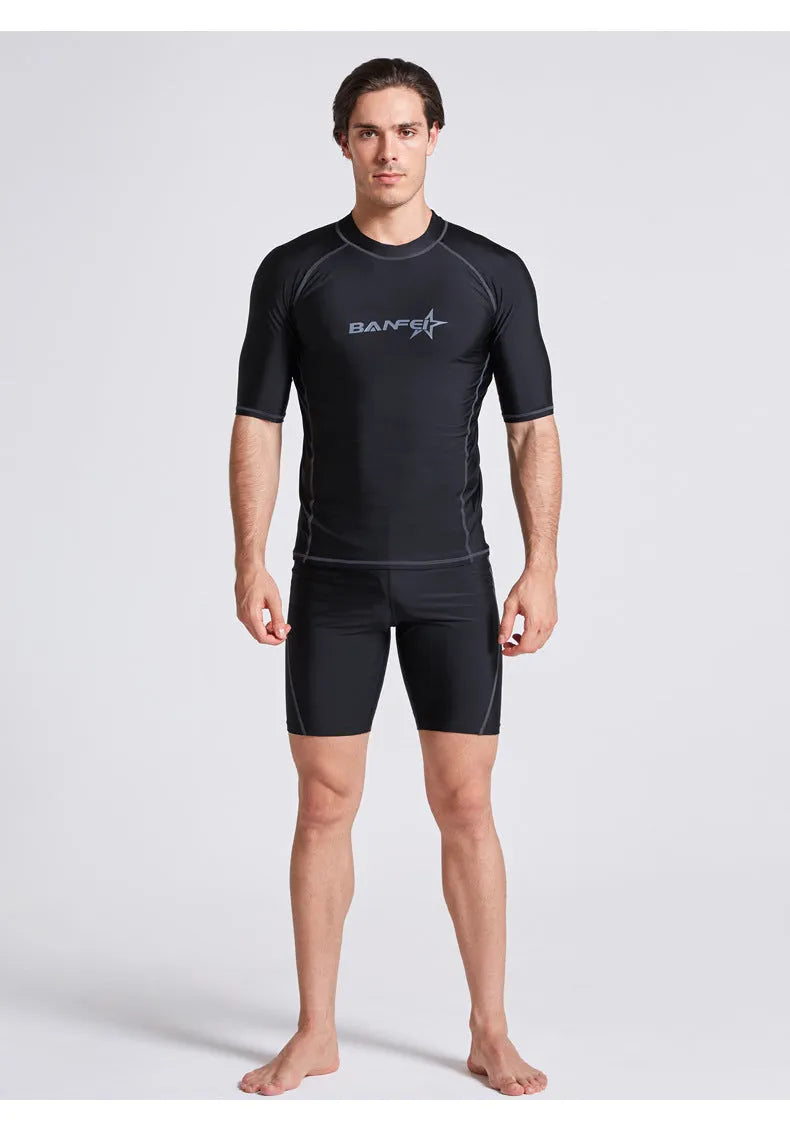 Men's navy blue quick-drying nylon swimsuit set with half-sleeve top and pants for swimming and surfing.