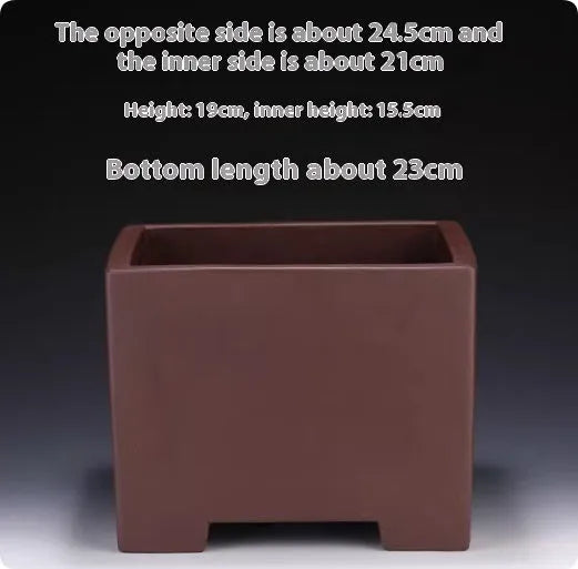 A square purple clay flower pot for succulents or bonsai plants on a tabletop.