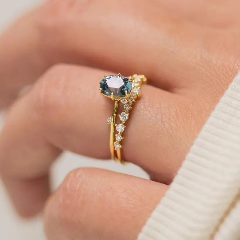 Gold electroplated women's ring with flower design featuring green zircon stones