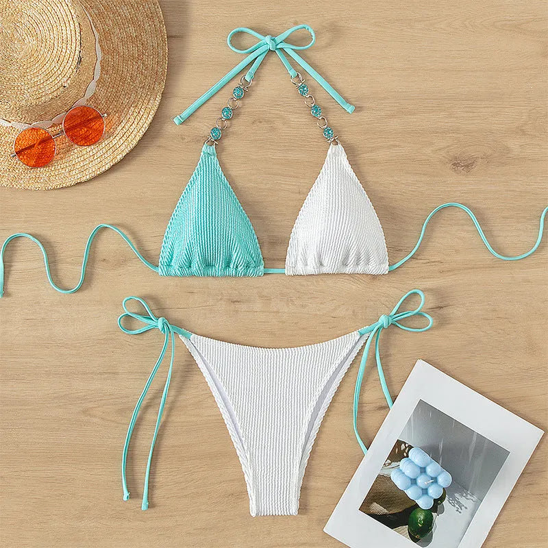 Women's colour matching nylon swimsuit set with lace-up pearl chain details and matching shorts.