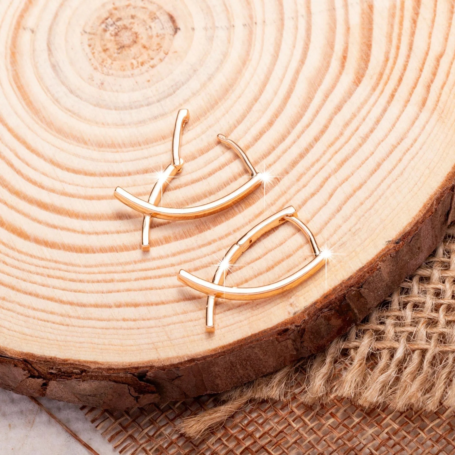 A pair of rose gold cross shaped fashion earrings on a copper alloy base.