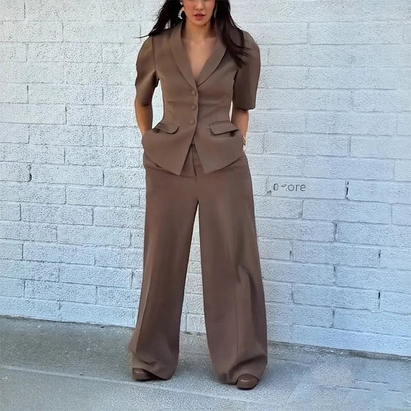 Brown men's slim fit polyester suit with long sleeve top and trousers on a hanger.