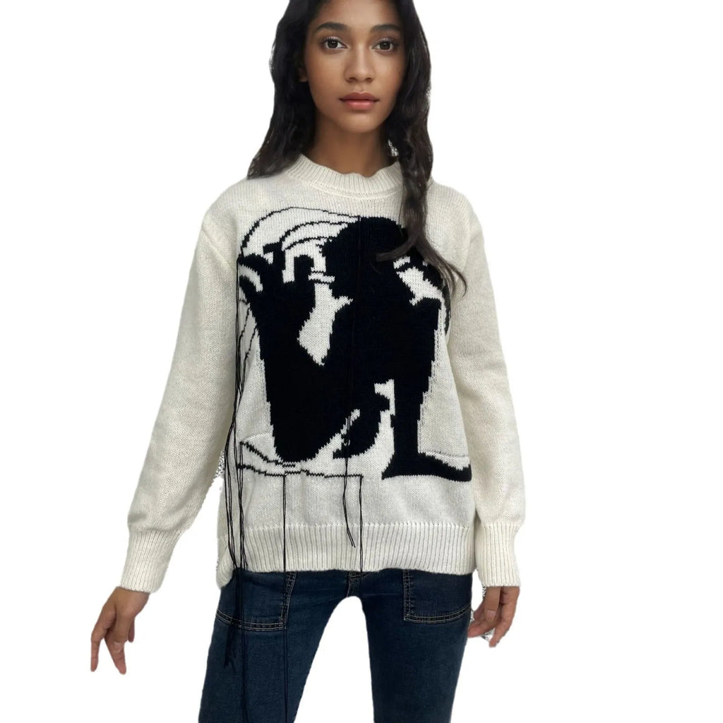 Grey women's loose alpaca wool sweater with a round neck, regular sleeves, and a long tassel detail.
