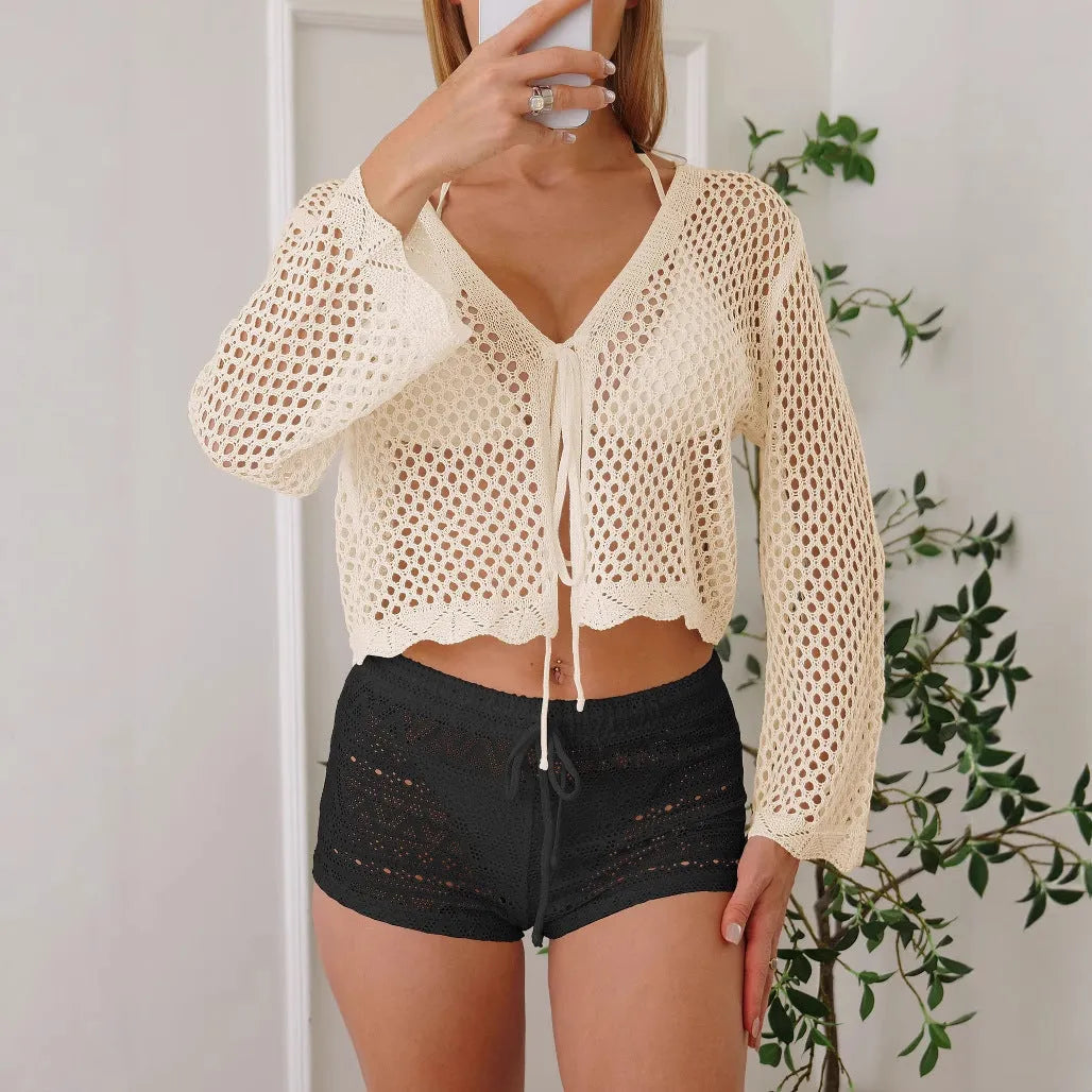 Women's short length cardigan blouse with nine-quarter bell sleeves in a hollow woven imitation cotton fabric.