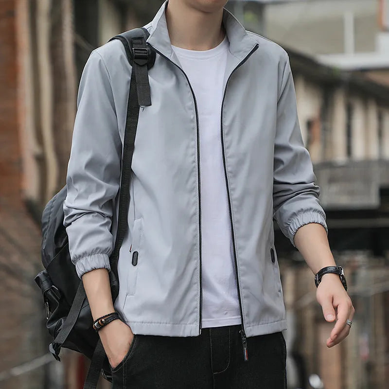 Korean style loose fit casual jacket in black with zip and patch pockets on a man.