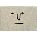 Square PVC floor mat with a cartoon face and geometric pattern in Mr. Big Nose colour.