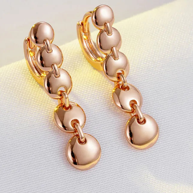 Gold woven copper circle earrings with retro circular design