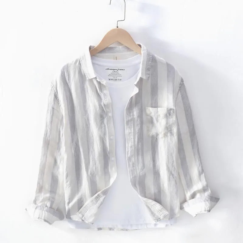 Men's blue loose-fit Hong Kong style long sleeve shirt on a hanger.
