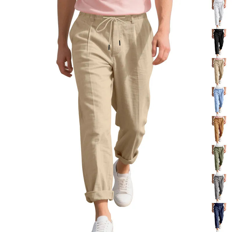 Men's light khaki linen casual trousers with a straight leg and drawstring waistband laid flat.