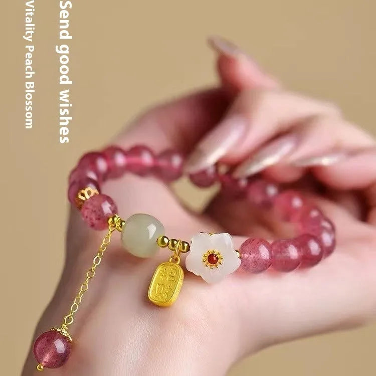 Handcrafted strawberry quartz crystal bracelet with green moon beads and peach blossom Hetian jade charm on adjustable string