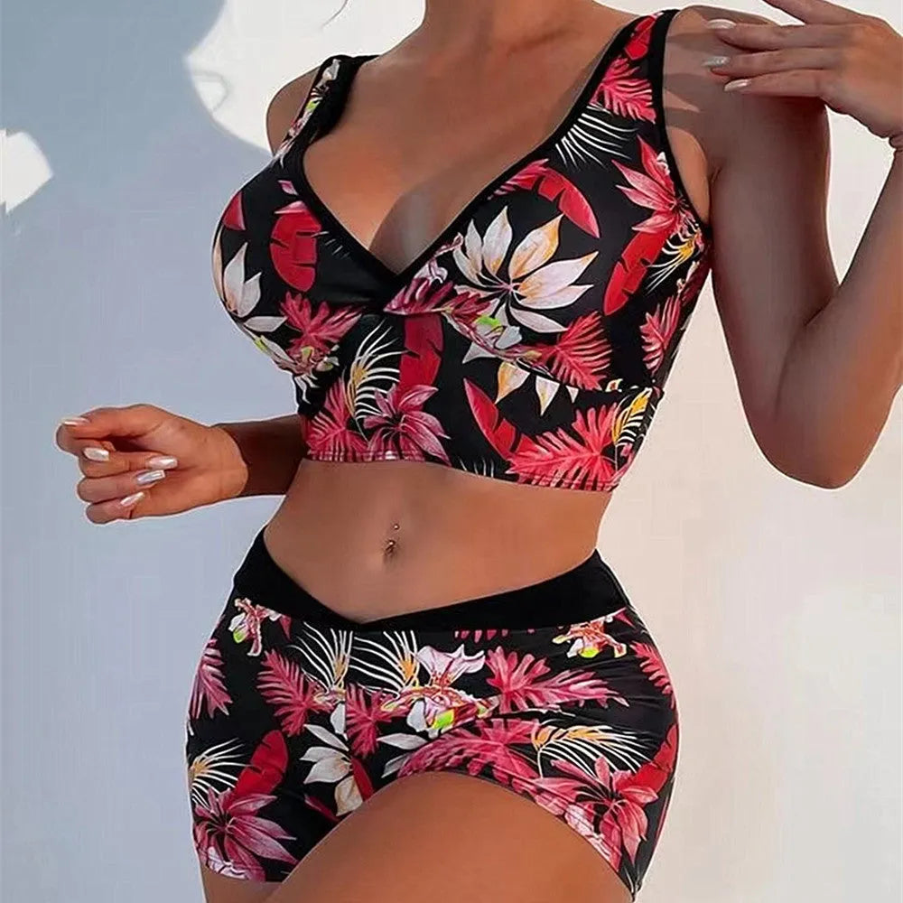Women's two-piece printed swimsuit with high-neck top and boxer shorts in a multi-colour design.