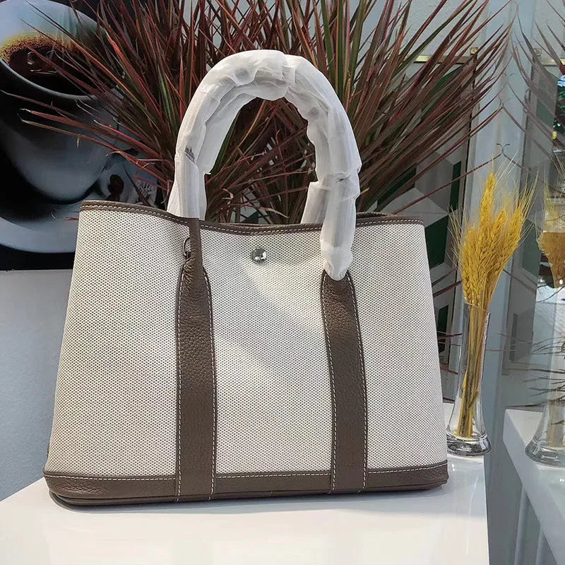 Women's canvas crossbody shoulder tote bag with leather detailing and bucket shape