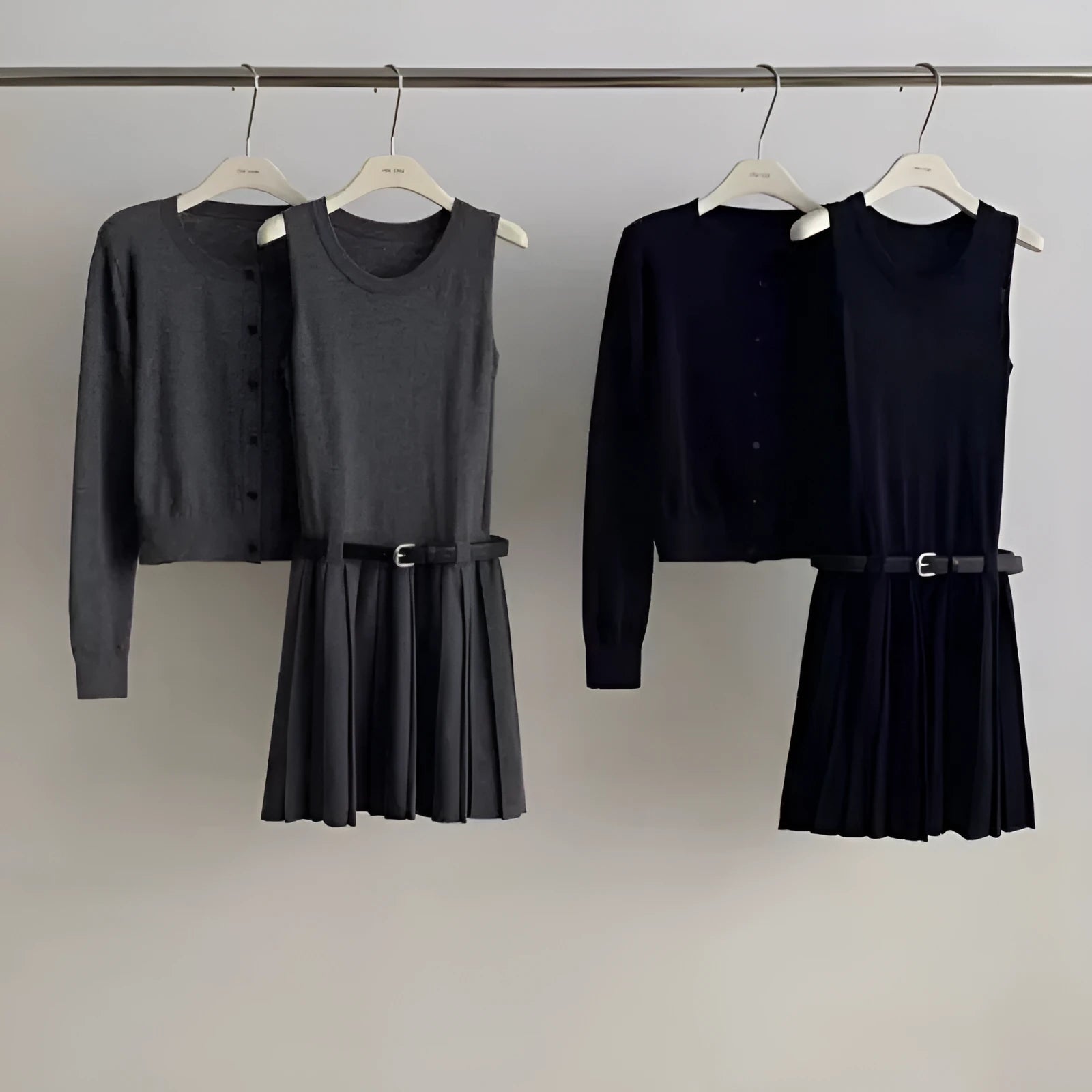Women's grey knitted two-piece set with vest skirt, long-sleeved cardigan, belt, and 3D pattern detail