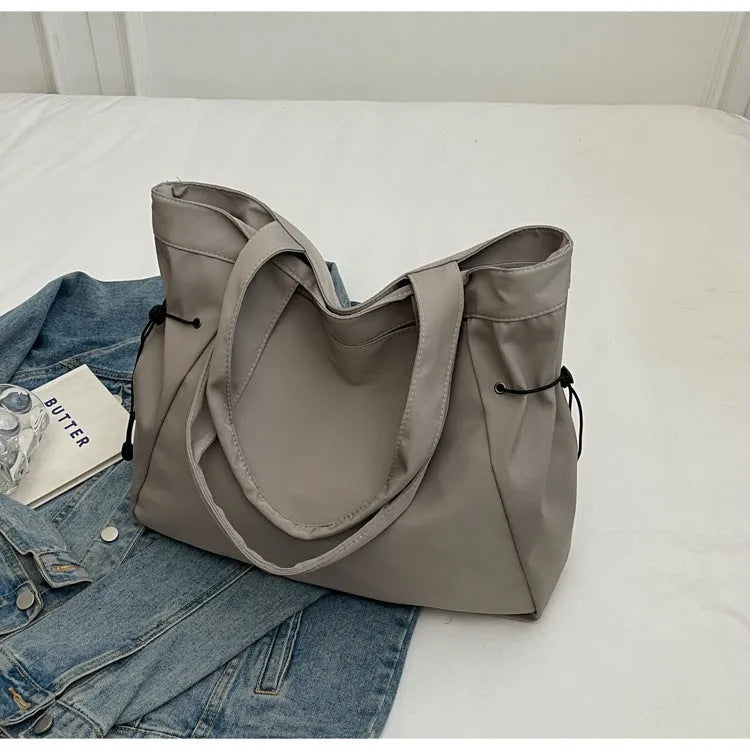 Soft Oxford cloth folding shoulder tote bag shown in available colour options