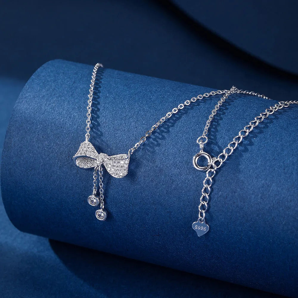 S925 sterling silver necklace with a bow pendant on an adjustable O-ring chain.