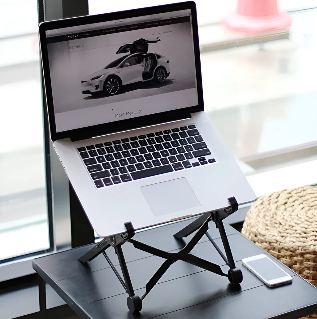 Black folding laptop stand made of reinforced nylon, shown in a compact folded size.