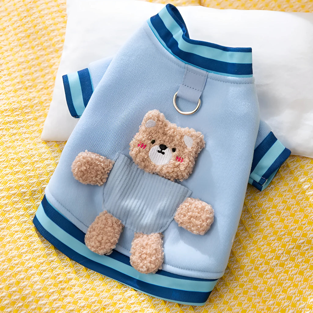 Soft navy blue dog sweater with light blue striped cuffs and blush bear decorations