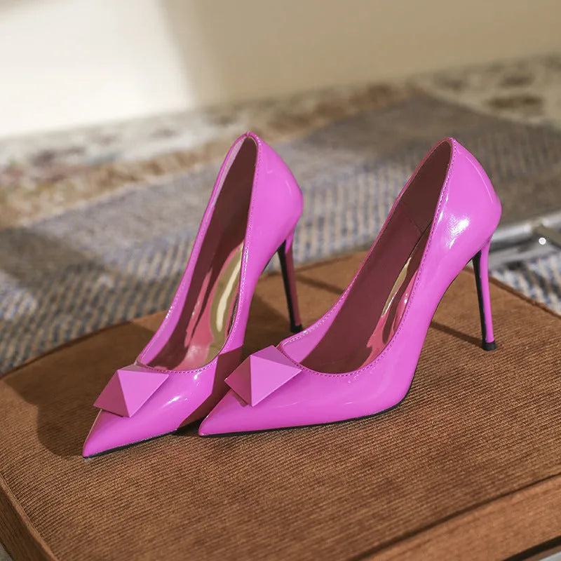 Pink patent leather women's pointed toe stiletto high heels with buckle and rivet detail