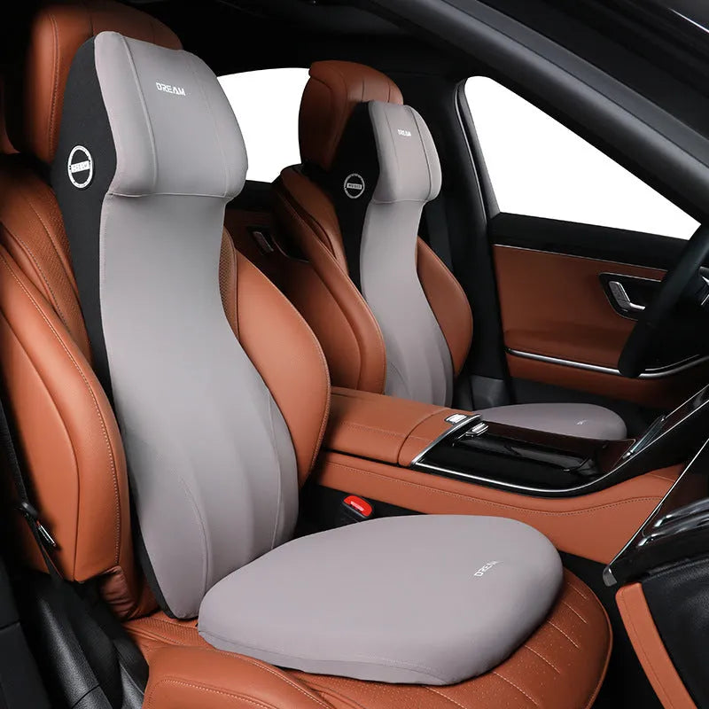 Black automotive memory foam headrest and lumbar cushion combined in one piece on a car seat.