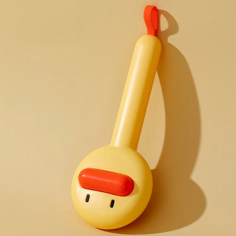 Small yellow duck-shaped pet comb with open sections and floating needles for cat and dog hair removal