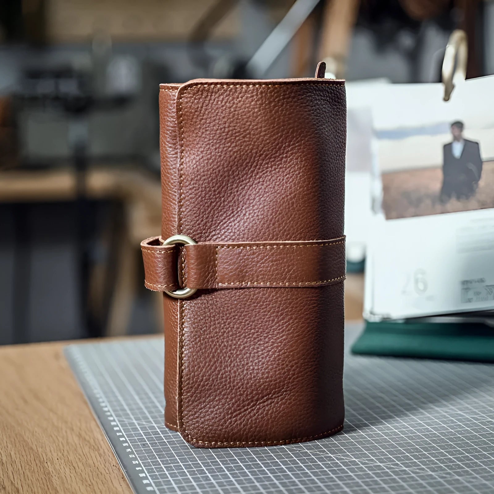 Handmade dark brown leather bifold wallet with tape extraction closure showing 20cm width