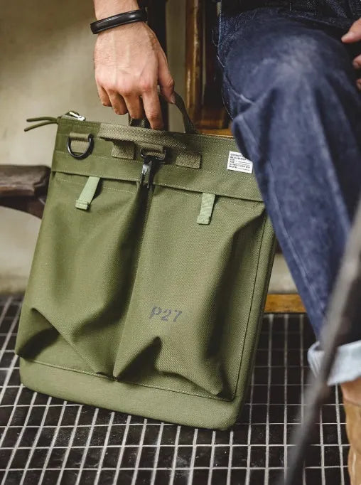 Medium vertical square canvas crossbody messenger bag in military green with shoulder strap
