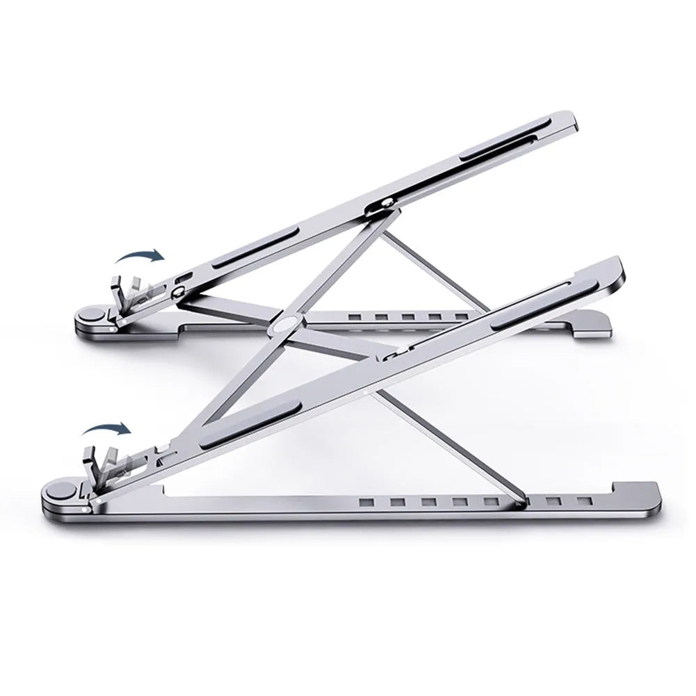 A folded silver aluminium laptop stand next to an open laptop, showing its thin profile and adjustable angle mechanism.