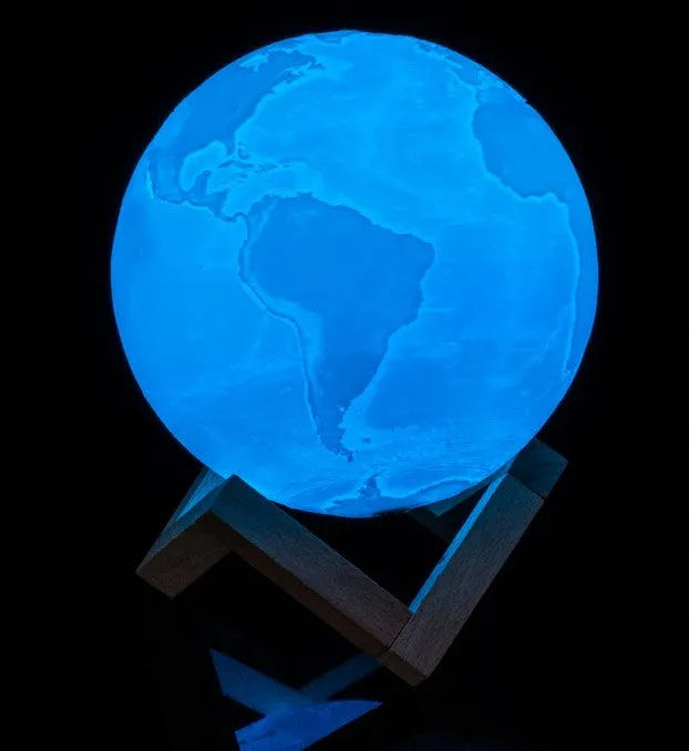 3D printed white moon lamp on wooden stand with colour-changing LED light