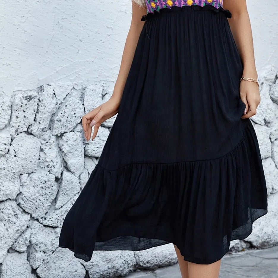 Purple sleeveless dress with hand-stitched floral embroidery on the front, shown on a mannequin.