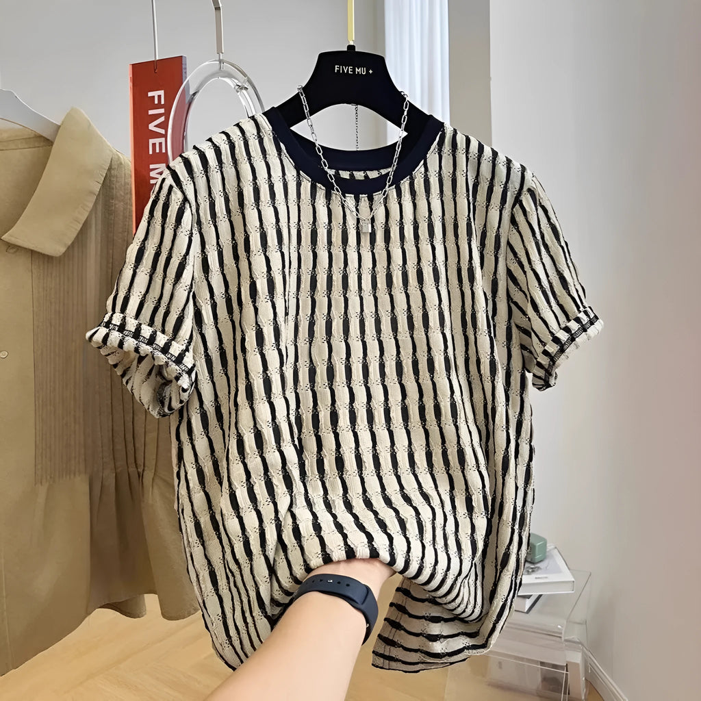 A man's loose-fitting black and white striped casual pullover shirt made from linen and silk.