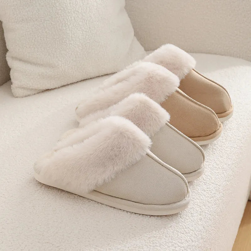 Women's brown plush indoor slippers with round toe, flat heel, and decorative stitching.