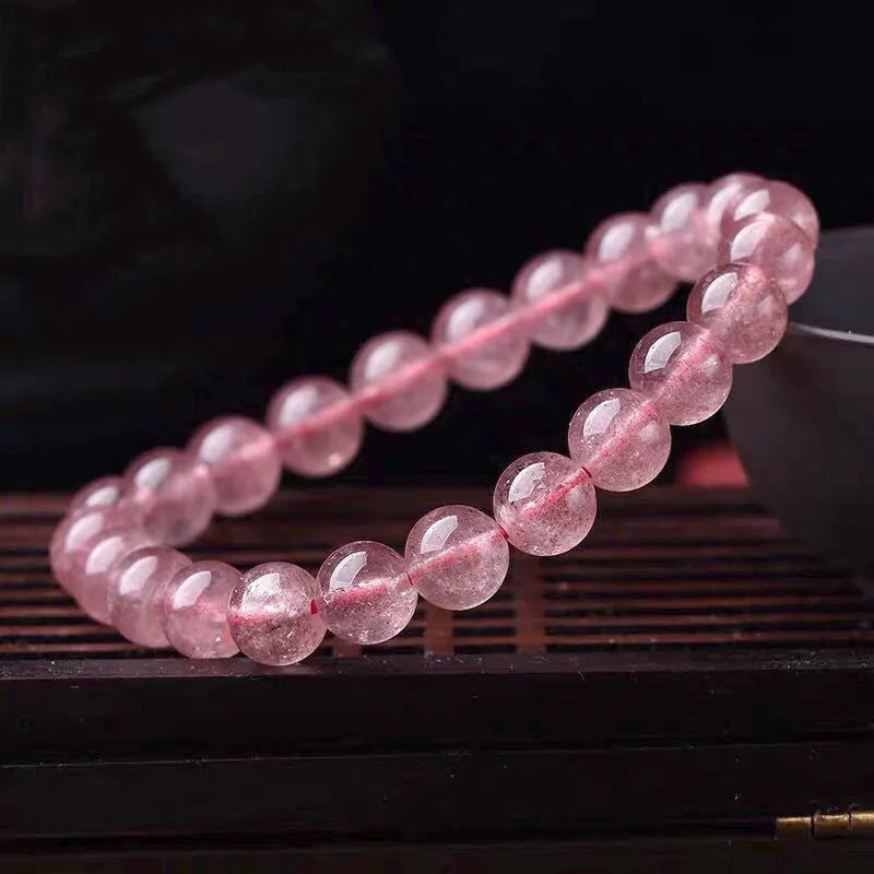 Women's strawberry quartz crystal bracelet with polished beads in three size options.