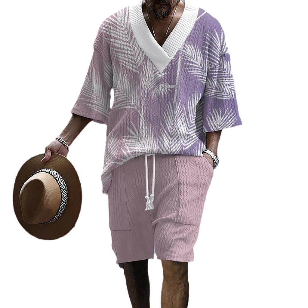 Man wearing a printed knitted drop-shoulder short-sleeved top with matching shorts from a co-ord suit set.
