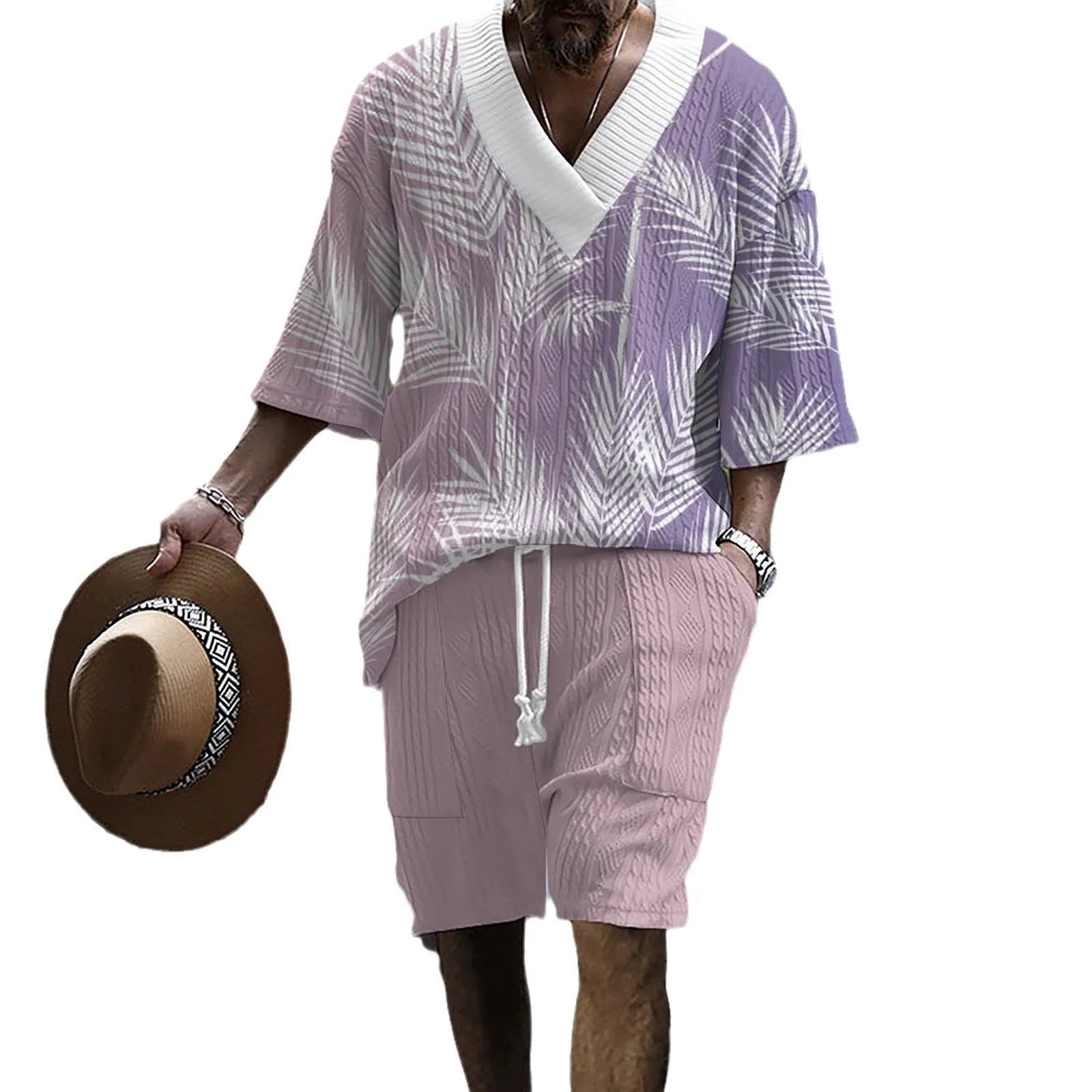 Man wearing a printed knitted drop-shoulder short-sleeved top with matching shorts from a co-ord suit set.