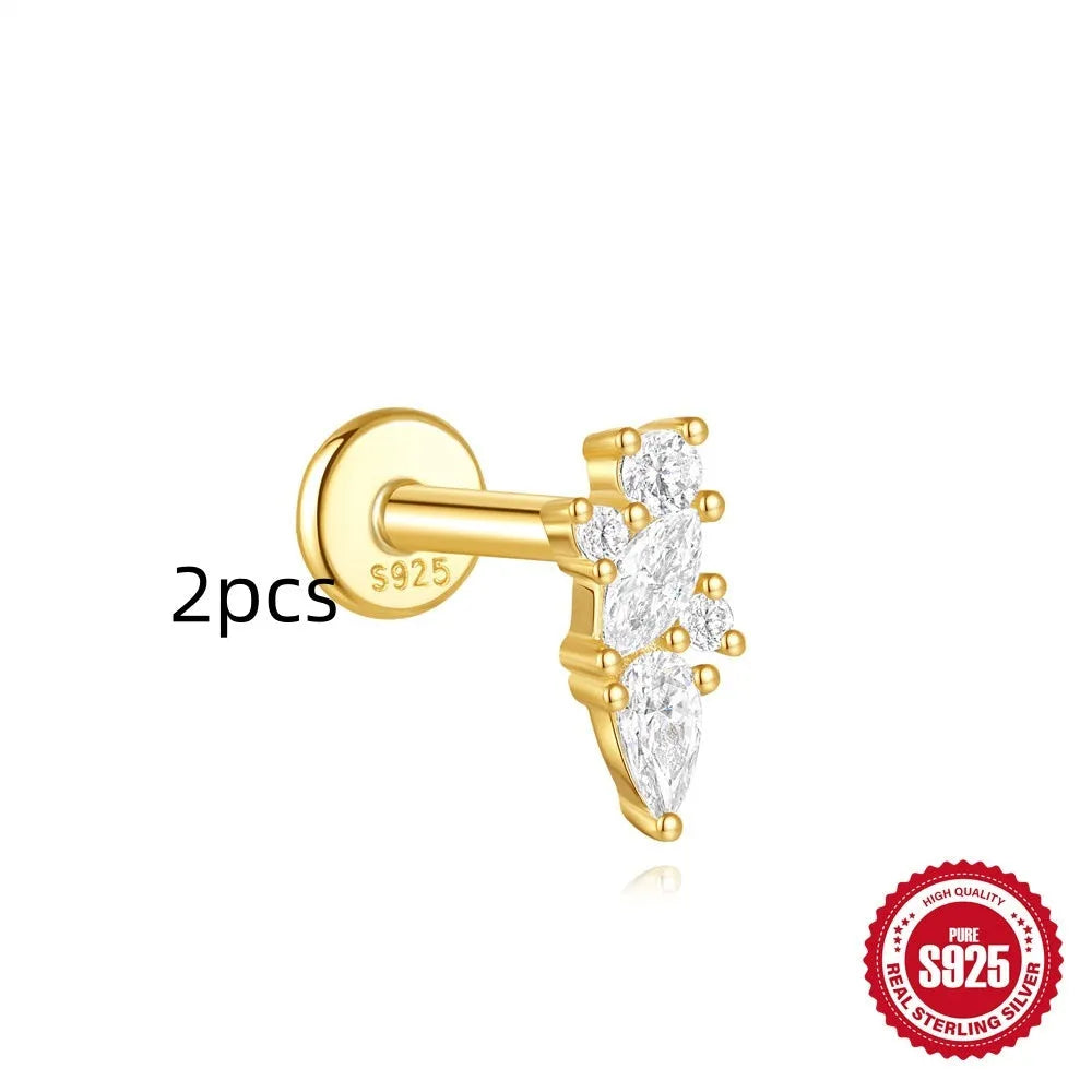 Geometric kite-shaped sterling silver earring with rhinestone head and gold chain tassel.