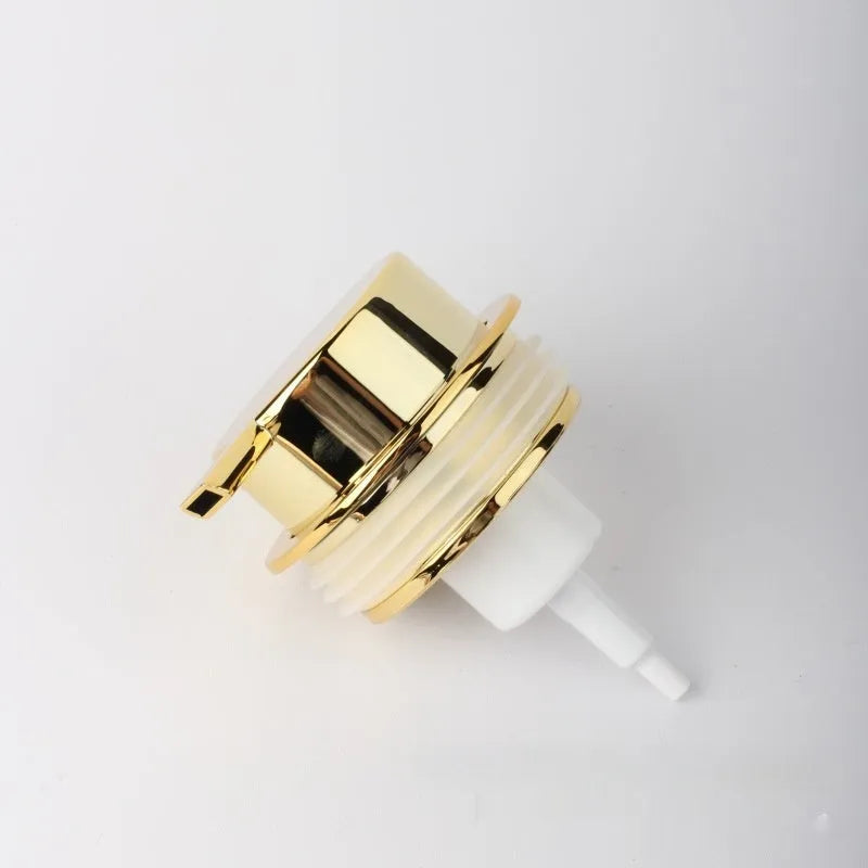 A large-headed foam pump for soap in a metallic gold finish, made from ABS plastic.